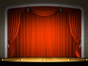 Empty stage with red curtain in expectation of performance